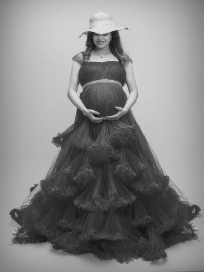 Feeling like a queen in this stunning black and white shot, featuring a dramatic ruffled gown and a chic hat.