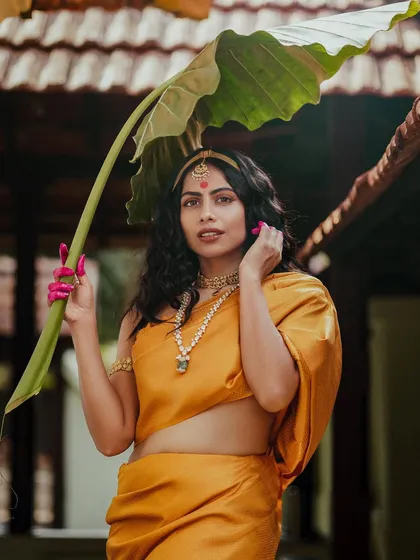 From my 'Thamara' series, this look reimagines traditional Indian attire with an artistic, Apsara-inspired drape. The vibrant yellow silk and minimal jewelry highlight a connection to cultural roots through a modern lens.