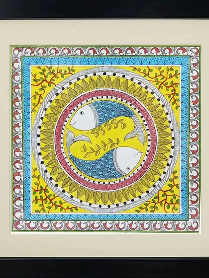 This circular Madhubani composition by Neha Kumari features two fish swimming in a yin-yang formation. The vibrant yellow and blue colors and leafy motifs create a lively and harmonious design.
