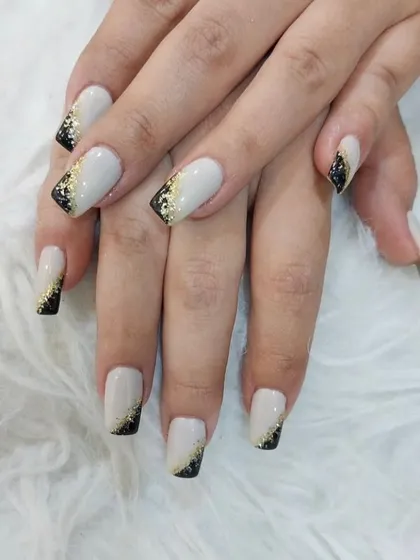 A chic and modern design with a matte white base and a corner accent of black and gold glitter.
