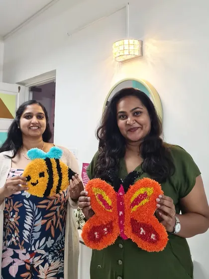 Sisters who tuft together! These two look so proud of their vibrant butterfly and bee rugs. It's a wonderful way to spend quality time together.