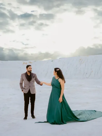 A classic walking pose in the unique white landscape of Kishangarh. The couple's formal wear contrasts beautifully with the raw, natural setting.