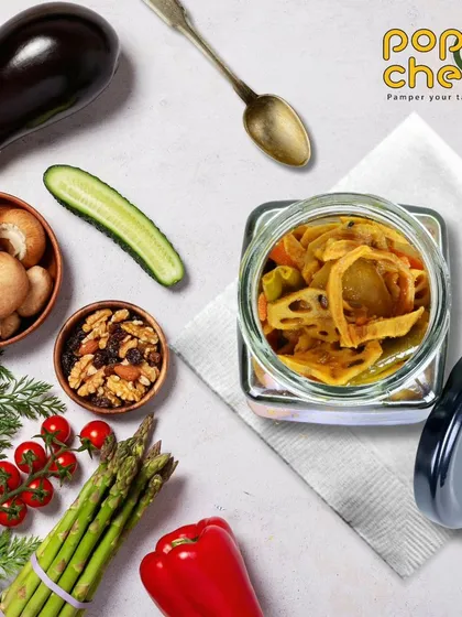 Our Real Mixed Pickle is a harmonious blend of garden-fresh vegetables. This jar is a symphony of colours and tastes, featuring hand-picked cucumbers, carrots, cauliflower, and lotus root.