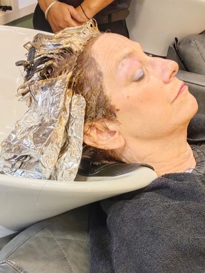 Relaxing at the shampoo station while the colour sets. I ensure my clients are comfortable throughout every step of their service.