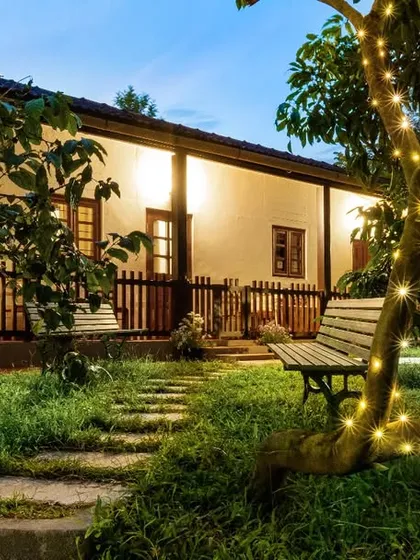 The garden of "Eorthe" illuminated by fairy lights, creating a whimsical and dreamlike setting. This shot captures the magical ambiance of the property in the evening.
