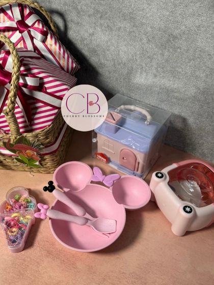 We designed these cute flamingo-themed birthday return favours for a little one's party. The cane basket includes a wheat grass plate and cutlery set, a piggy bank, a sipper, and a set of hair clips for girls.