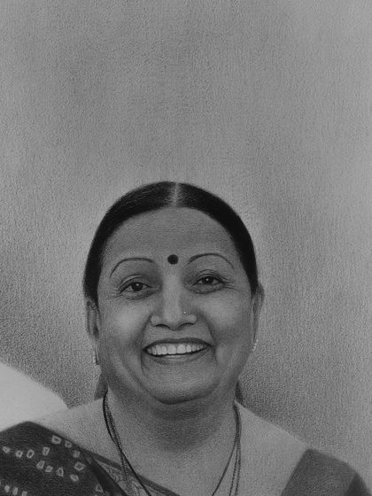 A detailed view of the wife's smiling face, where I used layers of graphite to create depth and a joyful expression.