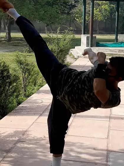 To teach powerful kicks, I maintain my own flexibility and strength. This is a demonstration of a high side kick, a fundamental move in martial arts that requires open hips and excellent balance.