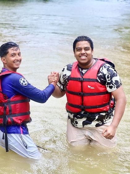 Two new friends shake hands in the river, a symbol of the camaraderie and connections made during our adventure courses.