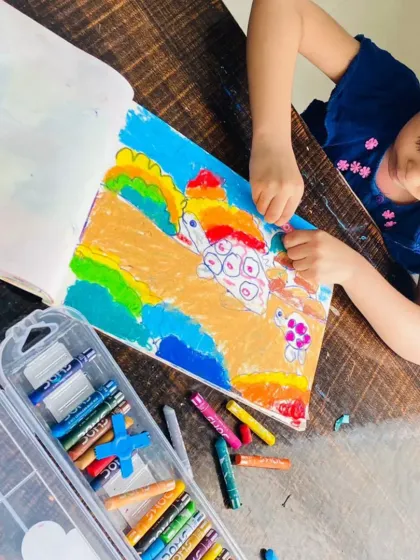 It's wonderful to see each child's unique take on the same subject. This little artist is adding her own creative flair to her tortoise drawing, using a mix of bold colors and patterns.