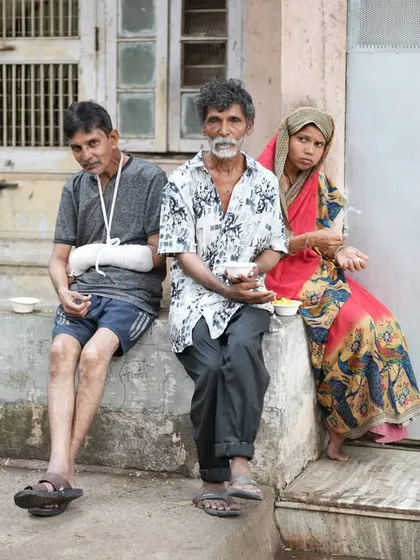 A family sitting together to eat. We believe that sharing food builds community and reinforces our shared humanity.