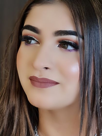 A side profile that captures the beautiful highlight on her cheekbones and the intricate eye makeup.