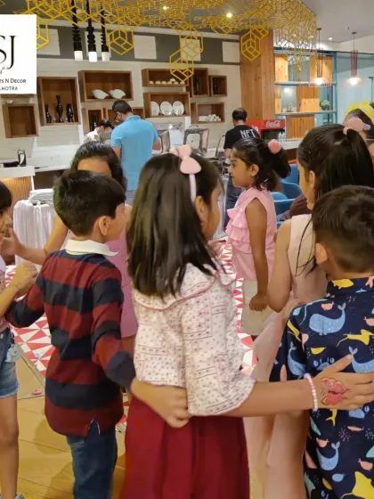 Kids engaged in a fun group game at a unicorn-themed party. We plan activities that encourage interaction and teamwork, ensuring all the young guests are included.