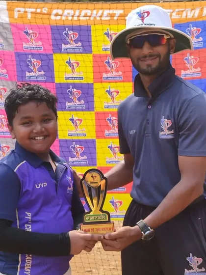 A happy U-10 player from the purple team is all smiles after being named Man of the Match.