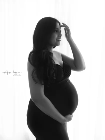 A duplicate of image 13, this soft and contemplative black and white portrait uses backlighting to create a beautiful and artistic silhouette.