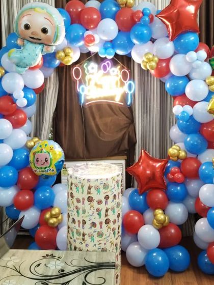 A clear shot of the Cocomelon balloon arch and backdrop, perfect for a cozy home celebration.
