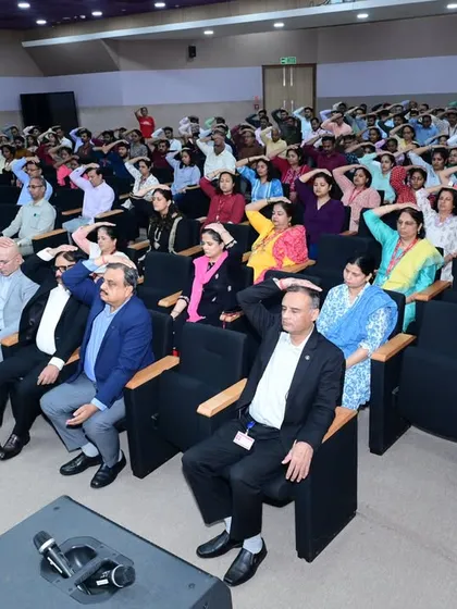 A moment of shared practice during a wellness session at ONGC, Vasundhara Bhavan. These workshops focus on simple, effective techniques like gentle stretches and mindfulness that can be easily integrated into a busy workday for immediate benefits.