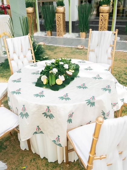 An outdoor dining table set for an event, featuring a printed tablecloth and a natural centerpiece. This shows my attention to detail in creating a complete and cohesive look for your celebration.