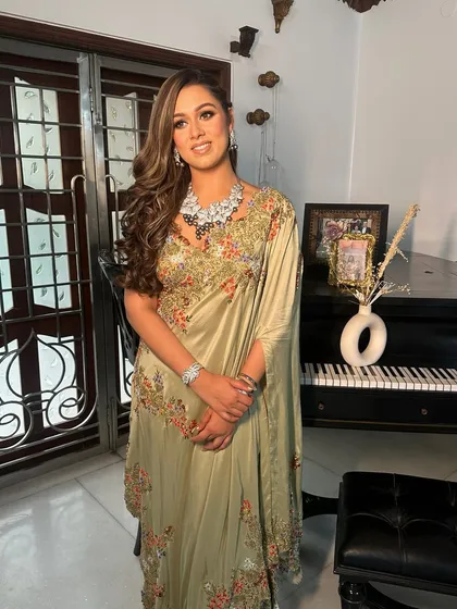 The full look, showing how the cosmic eye makeup pairs with a beautiful embroidered saree for a stunning sangeet ensemble.