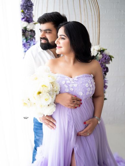 A sweet couple's portrait by the window. The floral birdcage prop creates a beautiful frame for this loving moment.