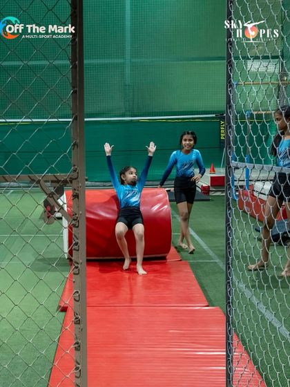 The joy of landing a move perfectly. This young gymnast celebrates after completing a drill on our padded equipment.