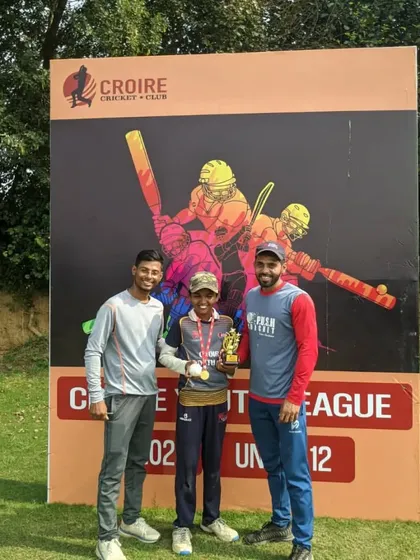 The coaches congratulating Aarav Srivastava on his well-deserved award.