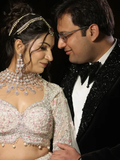 A beautiful close-up of the couple. The bride's makeup is soft and elegant, with a focus on her glowing skin and defined eyes.