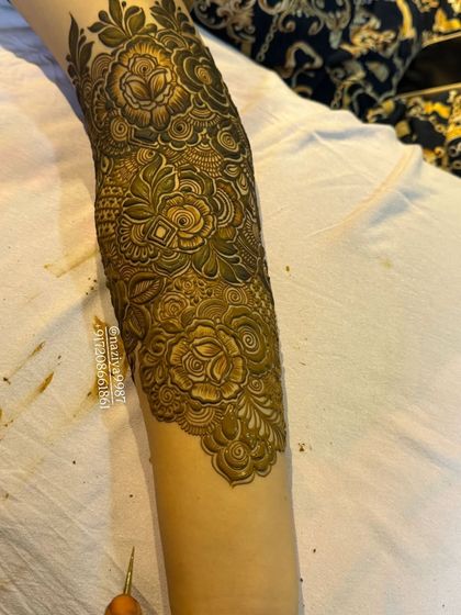 The lower part of the arm, showing how the design flows down to the wrist.