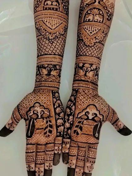 A traditional design featuring swan and peacock motifs, symbolizing love and beauty, set within intricate patterns covering the full arms.