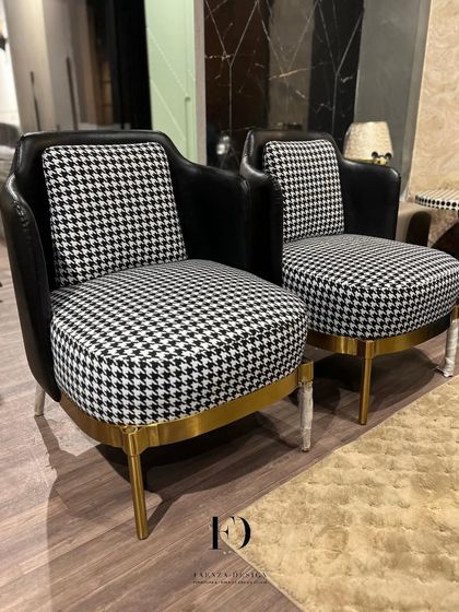 Bold and graphic, these accent chairs feature a classic houndstooth pattern paired with a black leather-like frame and a gold-finished base. They are designed to be conversation starters.
