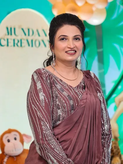 An elegant look for a mature client at a Mundan ceremony. The makeup is soft and sophisticated, complementing her mauve saree.