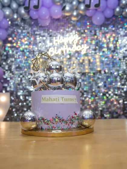 A close-up of the disco birthday cake, perfectly matching the lavender and silver color scheme. We coordinate with bakers to ensure every detail fits the theme.