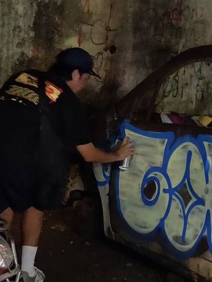 Here's artist Snaketwo painting on a rusted car during our session. Any surface can be a canvas when you're a graffiti artist.