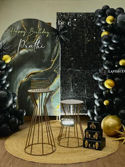 A sophisticated black, gold, and marble-effect backdrop paired with a shimmer wall panel. This setup is all about texture, contrast, and modern elegance.
