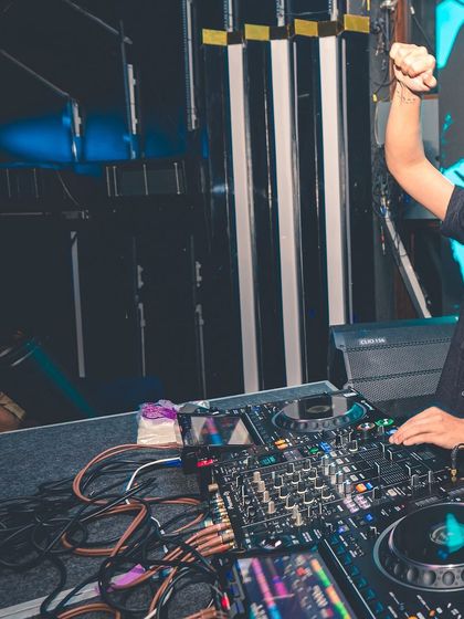 A shot of me with my fist in the air, feeling the energy of the track. I'm actively involved in the music, not just playing it.