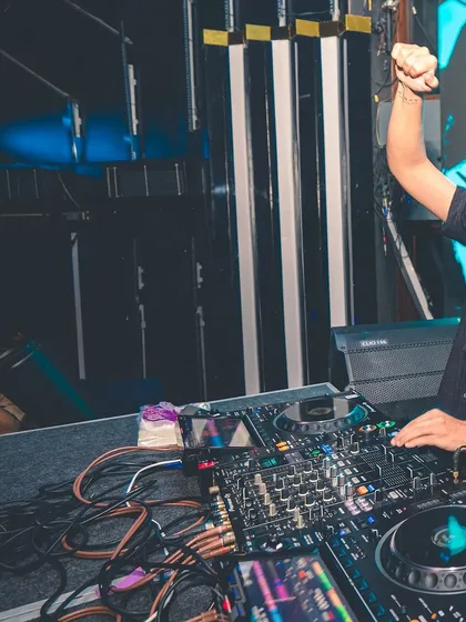 A shot of me with my fist in the air, feeling the energy of the track. I'm actively involved in the music, not just playing it.