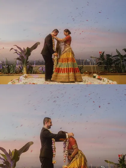 A collage of the varmala exchange against a magical sunset sky. The beautiful colors of the sky and the shower of petals create a truly romantic and cinematic scene.