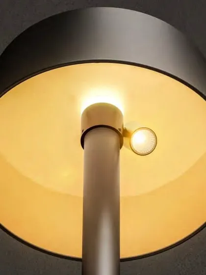 A view from underneath the solar lamp post, showing the warm, downward-cast light source. This design minimizes glare and directs illumination exactly where it's needed on pathways or seating areas.