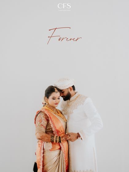 A minimalist and elegant couple portrait against a clean white background. This style puts all the focus on the couple's beautiful traditional attire and their emotional bond.