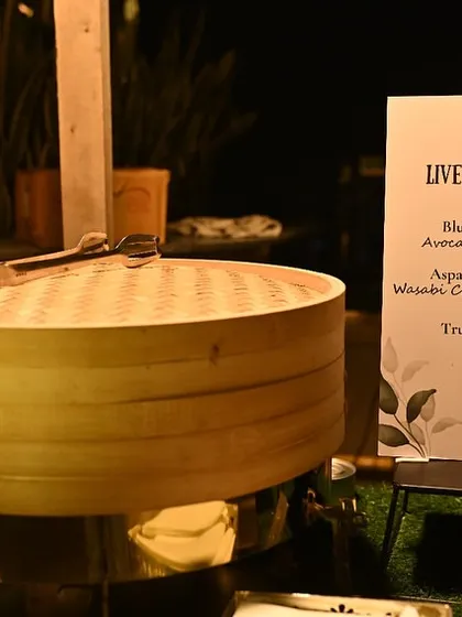 Our live sushi station, featuring a menu of Blue Pea Flower Sushi, Asparagus Tempura Sushi, and Truffle Shiitake Sushi, ready to delight guests.