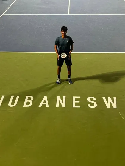 A champion's pose on the court where it all happened. Om Verma with his doubles winner's plaque at the ITF J30 Bhubaneswar, a result of his powerful gameplay and strategic partnership.