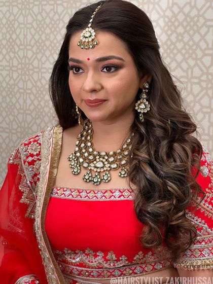 Another view of the classic half-up style, showing how it complements the client's Maang Tikka.