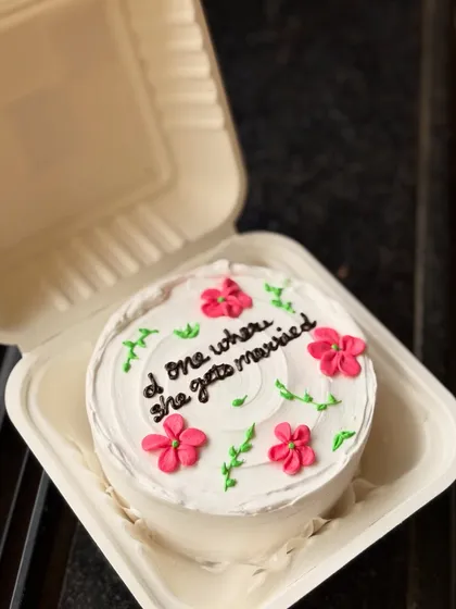 A "Friends" themed bento cake for a bride-to-be, saying "the one where she gets married". It’s a fun nod to the popular show, decorated with dainty flowers.