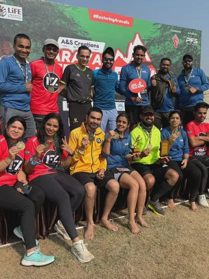 A group of triumphant runners from the Fit Zone team posing with their medals after the Aravali Trail Run.