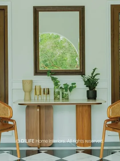 A closer look at the elegant entryway with its checkered floor, cane chairs, and simple console table, perfectly blending classic and contemporary design elements.