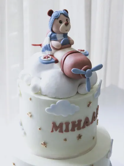The cutest welcome cake for baby Mihaan. This two-tiered design features a teddy bear pilot flying high above the clouds.