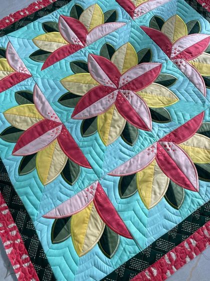 Another angle of the Big Bloom quilt, showing the ruler work quilting in the background.