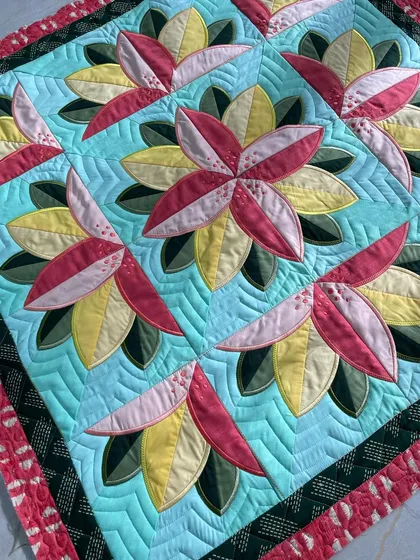 Another angle of the Big Bloom quilt, showing the ruler work quilting in the background.