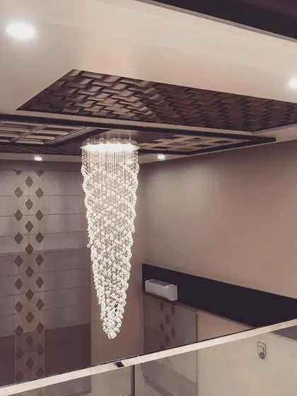 Another angle of the magnificent crystal chandelier, showcasing its intricate details and the way it reflects light.