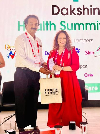 Receiving an award at the Dakshin Health Summit 2025. It is an honor to be recognized by my peers at such a significant event for the dermatology community.